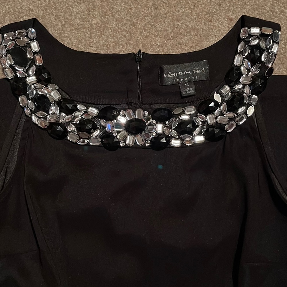 Sleek little black cocktail dress. Beautiful neckline detail. Great condition.